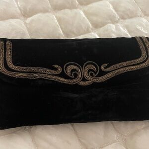 Beautiful vintage black velvet clutch. With gold accents. Excellent condition.